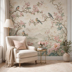 Nursery accent wall with pink chinoiserie bird wallpaper and soft botanical mural in pastel tones