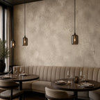 Aged European plaster wallpaper in greige tones bringing wabi sabi warmth to a neutral living room accent wall