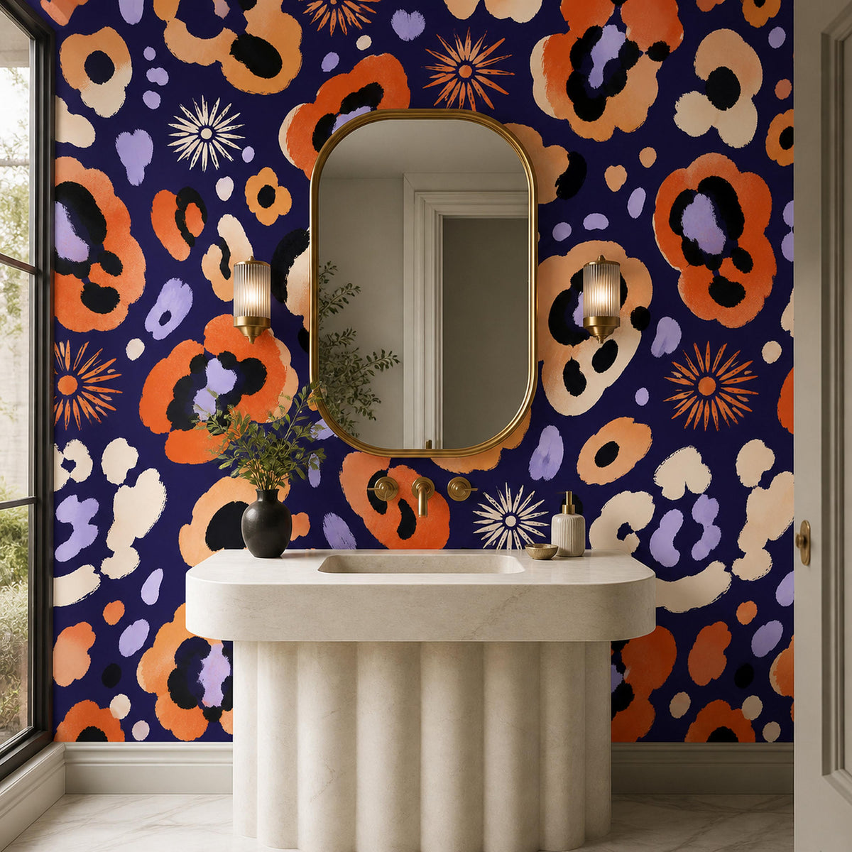 Indigo ocelot leopard print wallpaper in a bathroom with a fluted pedestal sink and gold-framed oval mirror