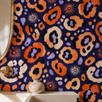 Indigo ocelot leopard print wallpaper close-up of the print with a white vase on a shelf