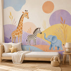 Safari nursery wallpaper mural behind a daybed with a star pillow and plush bunny