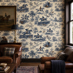Cobalt blue equestrian toile wallpaper in a living room with leather armchairs, plaid cushions and a horse painting