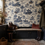 Cobalt blue equestrian toile wallpaper in a mudroom with a saddle, riding boots and a cushioned bench