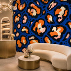 Cobalt leopard wallpaper in a boutique lounge with a curved cream sofa and gold coffee table