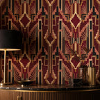 Burgundy Art Deco wallpaper behind a brass lamp with a black shade on a dark marble counter