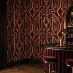 Burgundy Art Deco wallpaper in a home bar with a curved velvet counter, gold stools and brass lamp