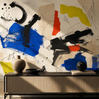 Abstract color block mural on a living room accent wall with modern furniture and gallery wallpaper vibes