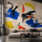 Creative studio workspace featuring a bold blue red yellow abstract wall mural as a statement backdrop