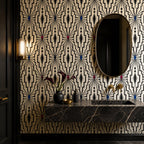 Living room statement wall covered in black geometric wallpaper with ivory art deco lattice design