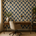 Navy herringbone wallpaper in a study with a wooden writing desk, cream office chair and brass lamp