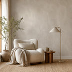 Close-up of faux plaster wallpaper texture showing natural mottled finish in soft neutral greige tones