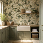 Sage frog botanical wallpaper in a laundry room with sage cabinets and a farmhouse sink
