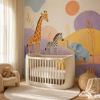 Safari nursery wallpaper mural behind a round white crib with a small armchair and teddy bear