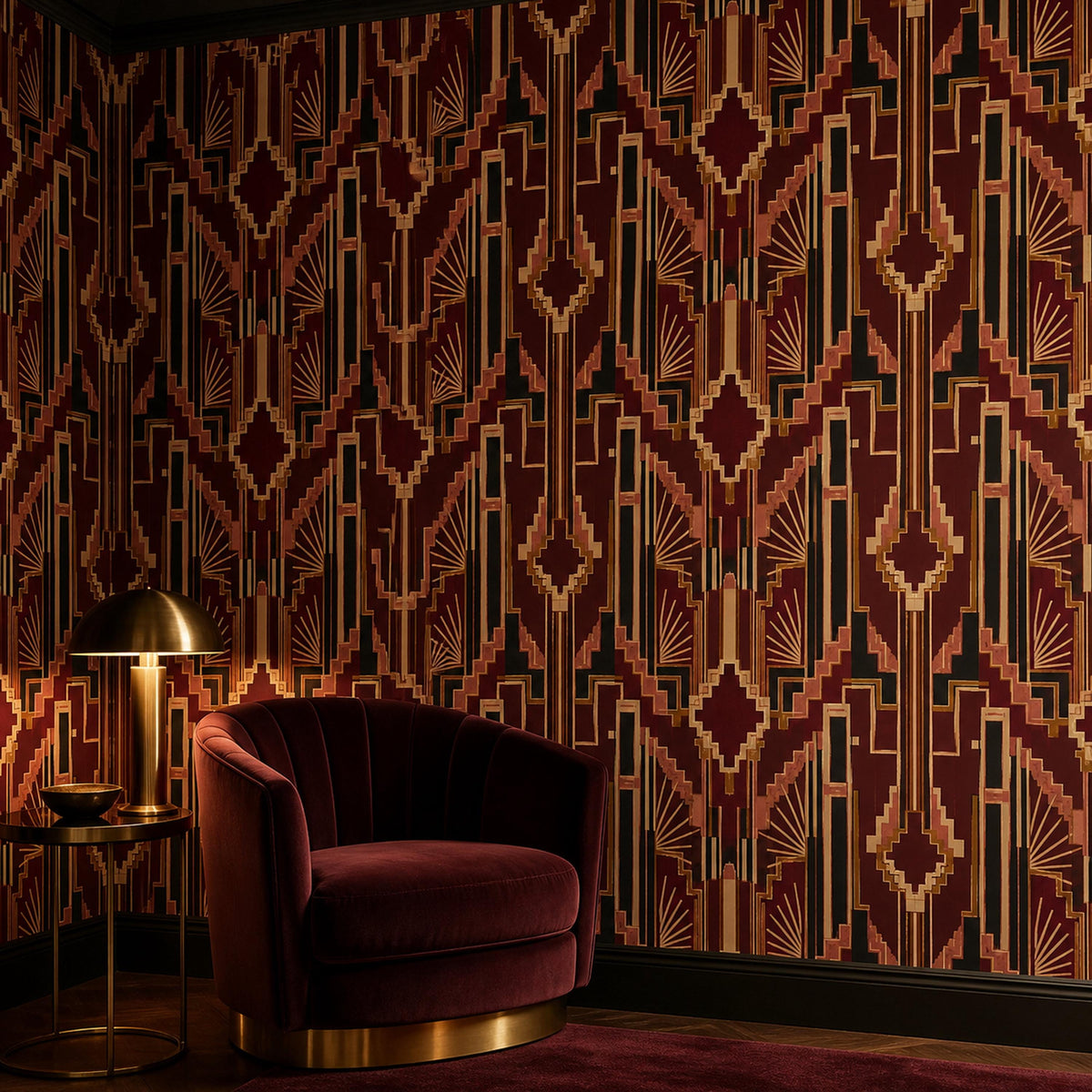 Burgundy Art Deco wallpaper in a sitting area with a burgundy velvet armchair and brass table lamp