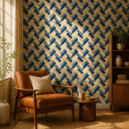 Navy herringbone wallpaper in a reading corner with a tan leather armchair and wooden bookshelf