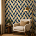 Navy herringbone wallpaper with a cream armchair, brass floor lamp and small side table
