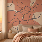Corner wall installation of navy continuous ribbon art mural with coral tones in a minimalist space