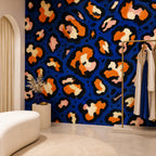 Cobalt leopard wallpaper in a dressing area with a white boucle bench and garment rack