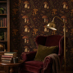 Dark plum mushroom toile wallpaper in a reading corner with a burgundy wingback chair and brass floor lamp