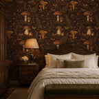 Dark plum mushroom toile wallpaper in a bedroom with a wooden headboard, table lamp and velvet bench