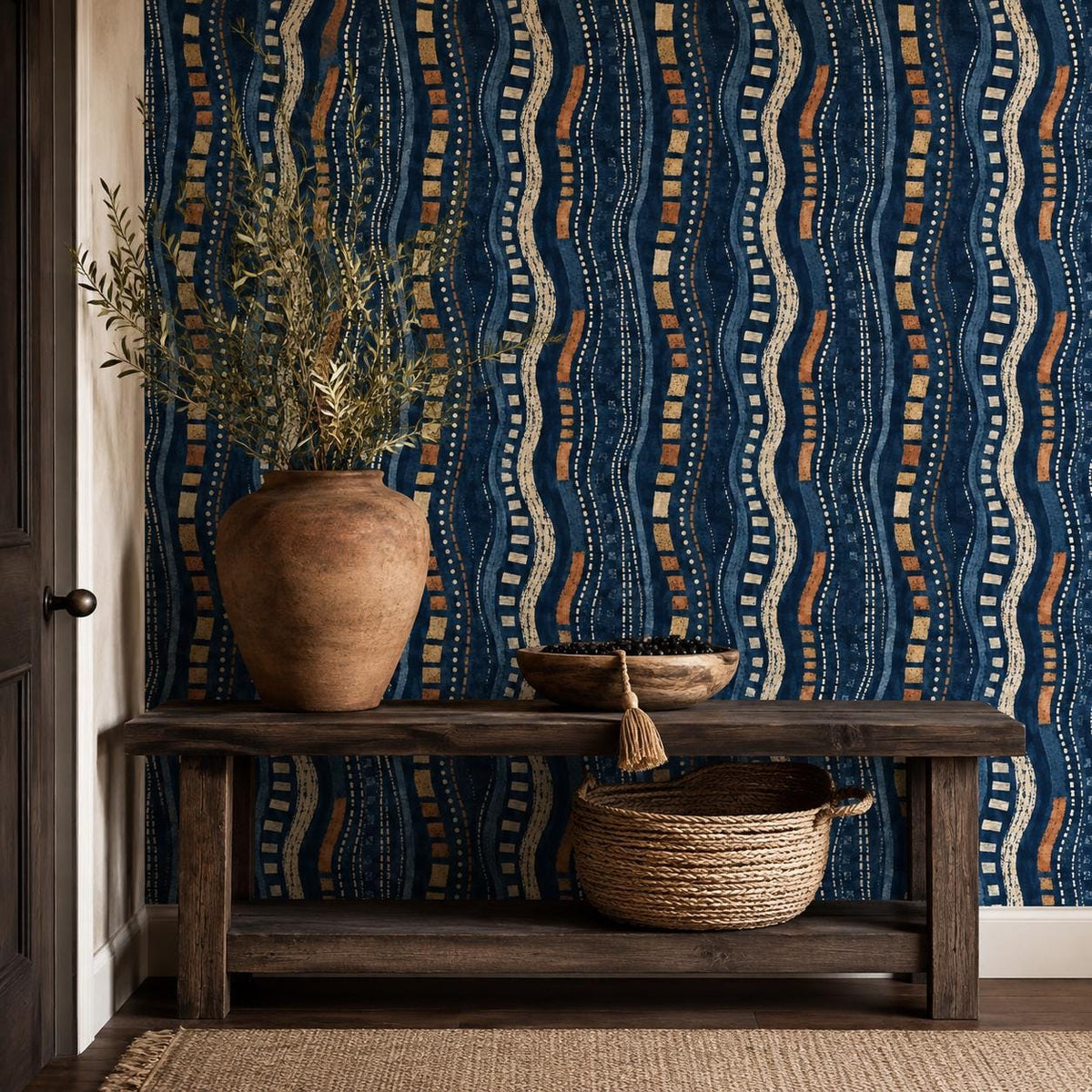 Afrohemian indigo mudcloth wallpaper in an entryway with a rustic wooden console, clay vase and woven basket