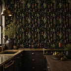 Kitchen witch dark botanical wallpaper in a kitchen with a brass pendant, dark cabinets and marble countertop