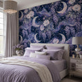 Celestial moon and wisteria wallpaper in a bedroom with lavender bedding and a white nightstand