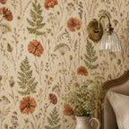 Pressed flower wallpaper close-up of poppies and ferns beside a brass wall sconce