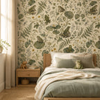 Sage frog botanical wallpaper behind a bed with sage green bedding and a wooden nightstand