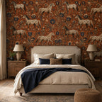 Terracotta folk art horse wallpaper in a bedroom with an upholstered bed, navy throw and bedside lamps