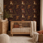 Dark plum mushroom toile wallpaper in a nursery with a wooden crib, knit pouf and wooden dresser