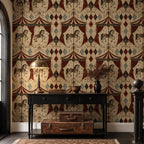 Oxblood harlequin circus wallpaper in a hallway with a black console, brass lamp and vintage suitcase