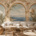 Greek fresco Aegean arch mural in a dining nook with a built-in cream banquette and wooden chairs